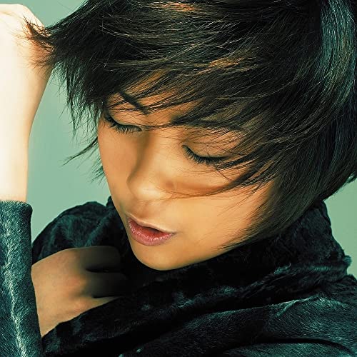 Close-up of Hikaru Utada with dark hair and eyes closed, vinyl record.