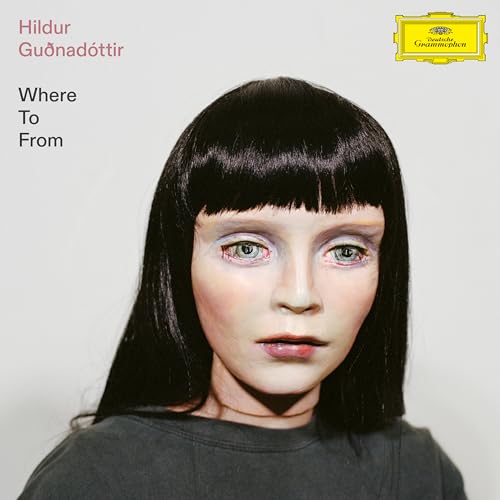 Album cover featuring a pale, doll-like person with dark hair against a white background.