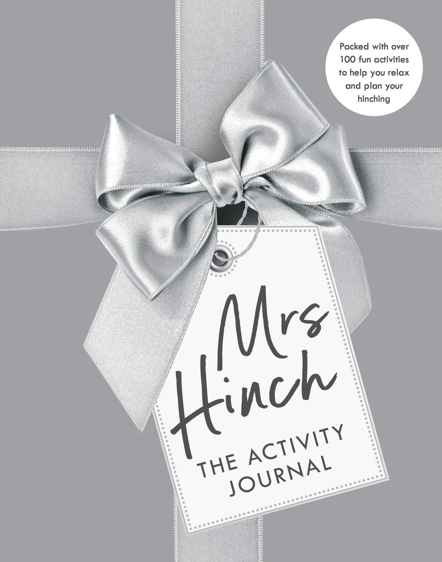 "Mrs Hinch: The Activity Journal" book cover with gift tag and ribbon on gray background.
