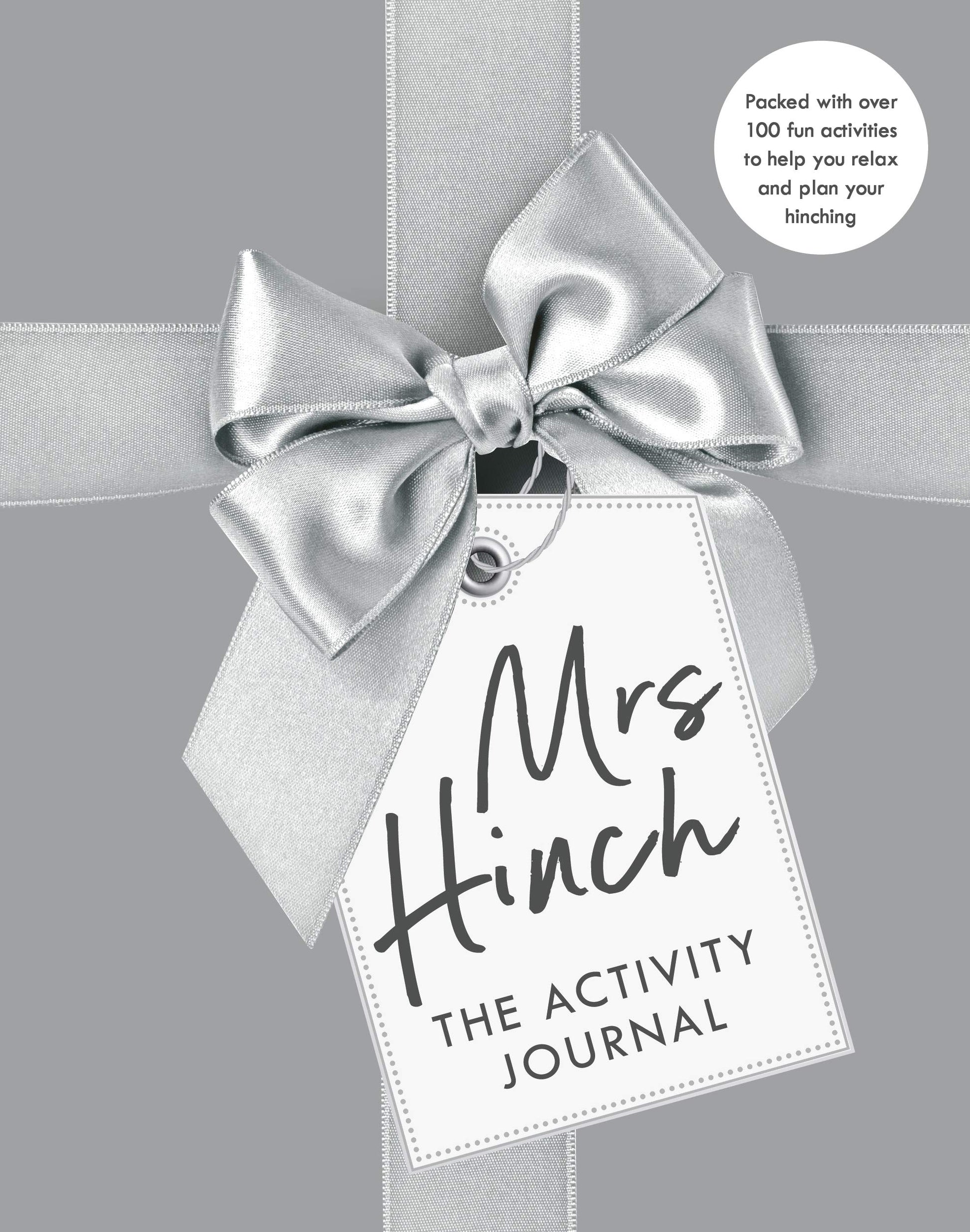 "Mrs Hinch: The Activity Journal" book cover with gift tag and ribbon on gray background.