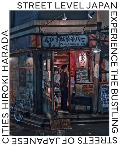 Small Japanese restaurant storefront with people inside, nighttime scene.