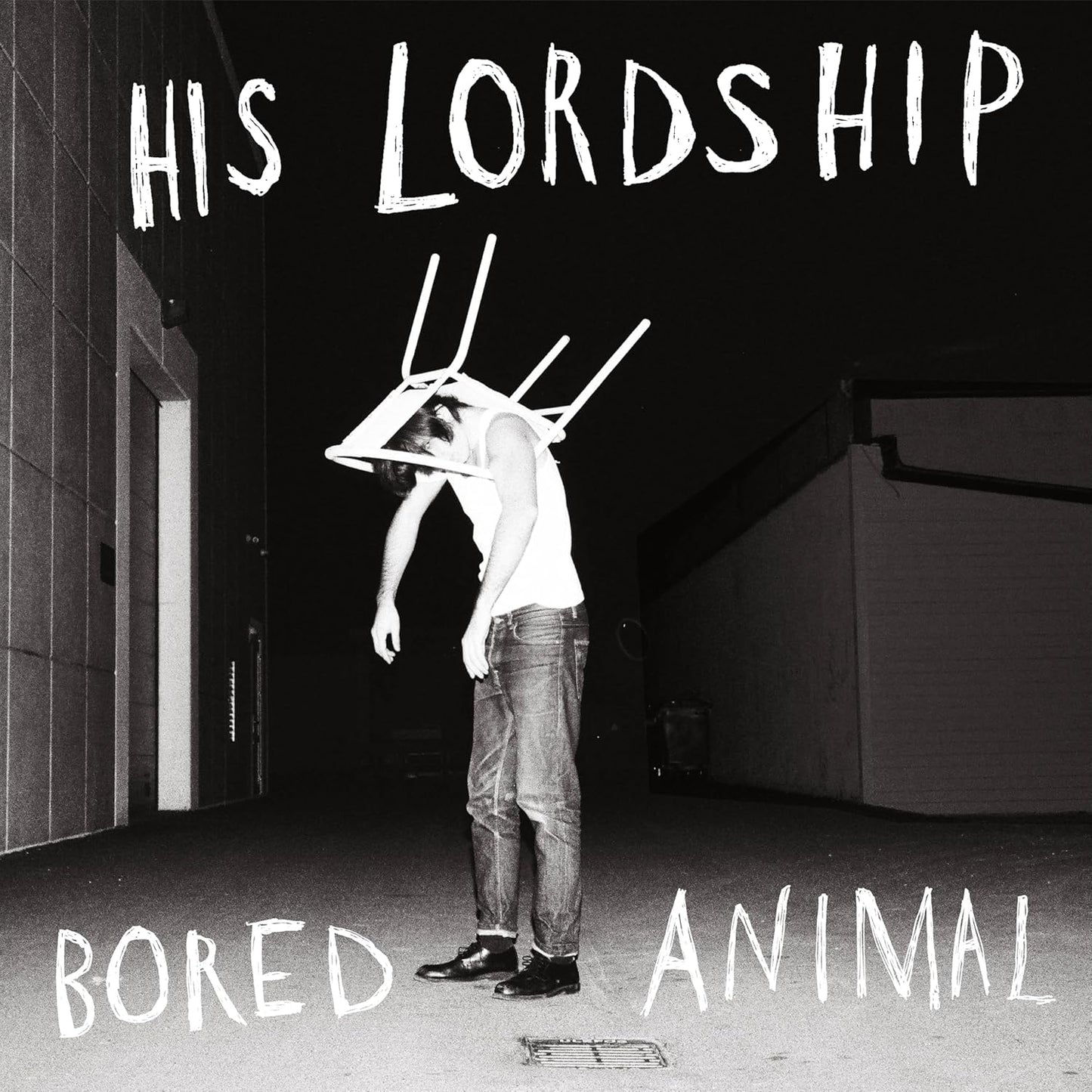 Black and white album cover with a person and chair on their head.