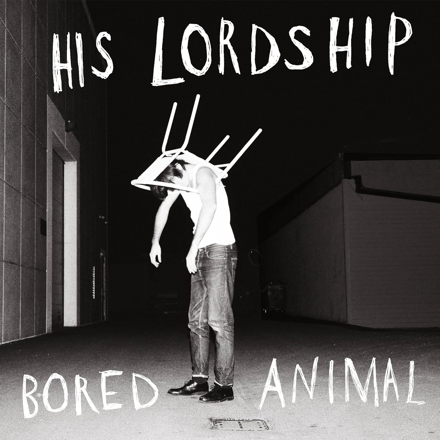 Black and white album cover with a person and chair on their head.