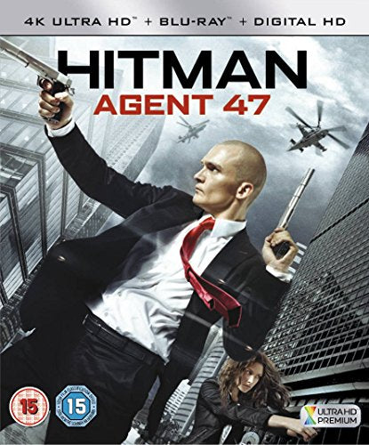 "Blu-ray case featuring a bald man in a suit holding guns."