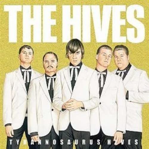 The Hives band members in white suits on a yellow background.