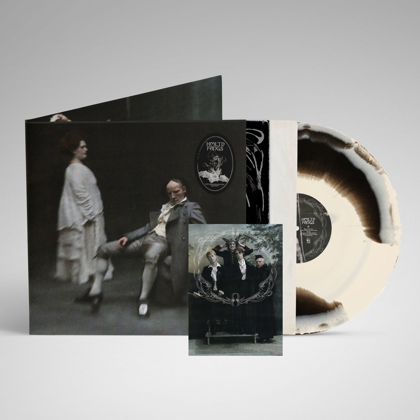 HMLTD "Fangs" vinyl record with splatter effect and gothic-style cover art.