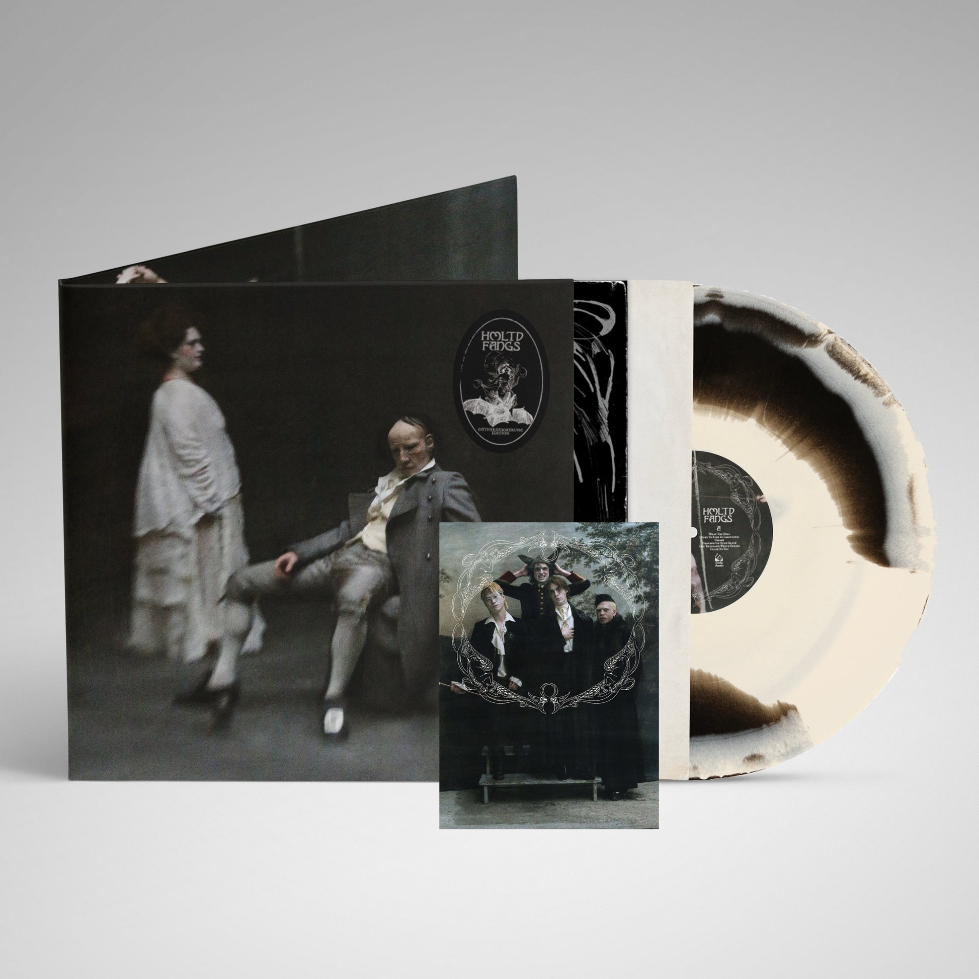 HMLTD "Fangs" vinyl record with splatter effect and gothic-style cover art.