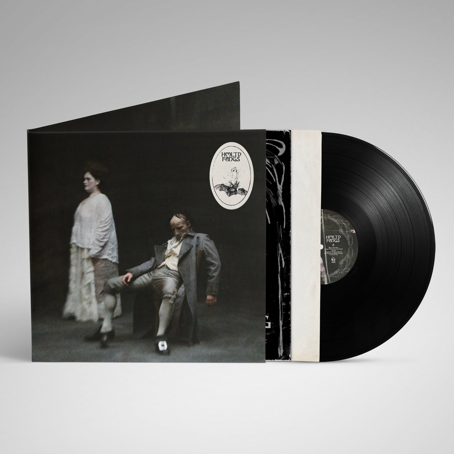HMLTD "Fangs" vinyl record with cover depicting figures in period clothing.