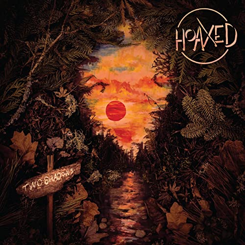 A red sun sets over a dark forest path with a wooden signpost.