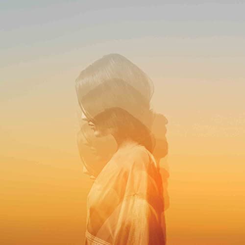 Woman’s blurred face in orange and yellow, album cover art.