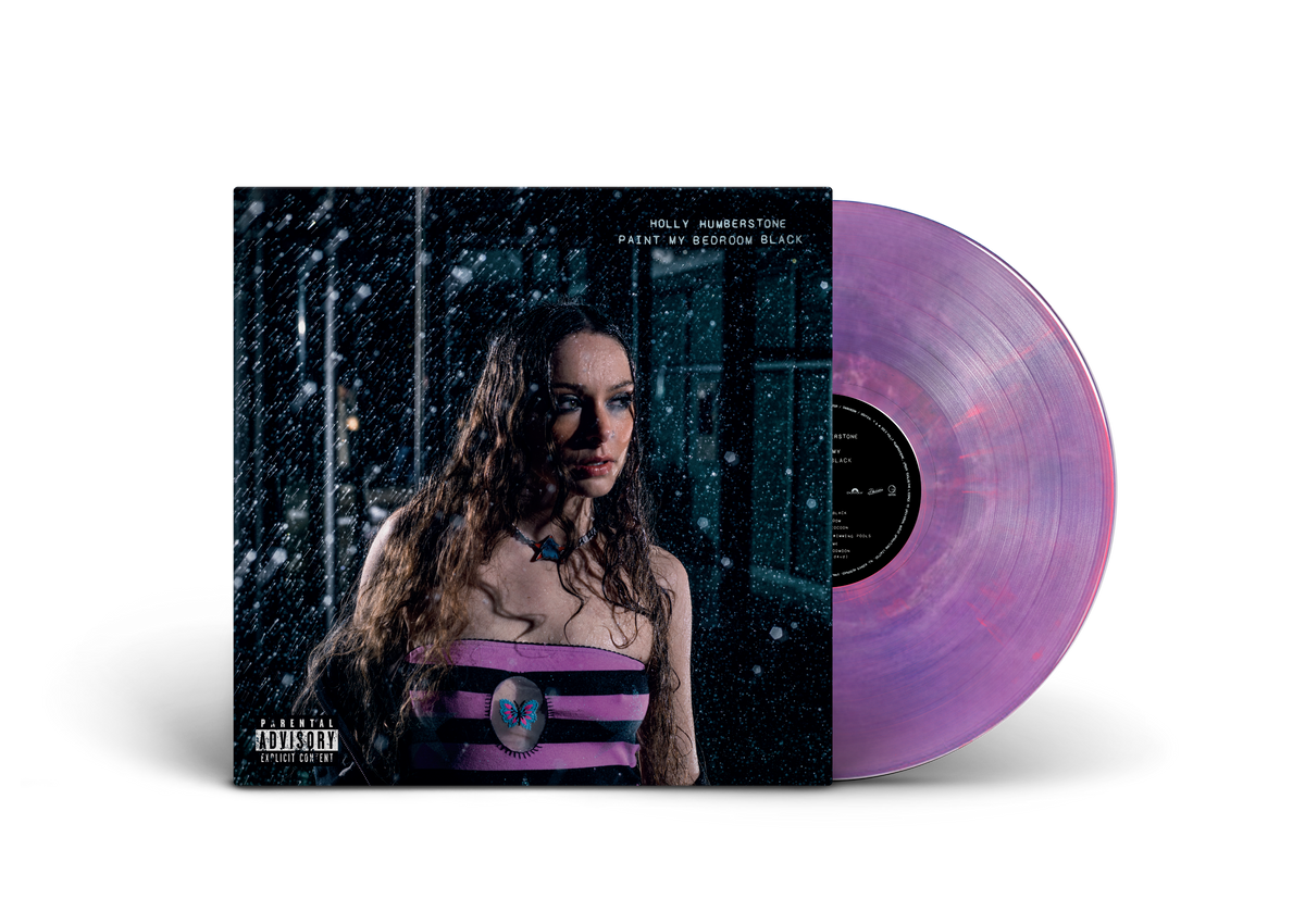 "Purple vinyl record with album cover featuring a woman in a purple striped top."