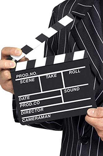 A person in a pinstripe suit holding a black and white film clapperboard.