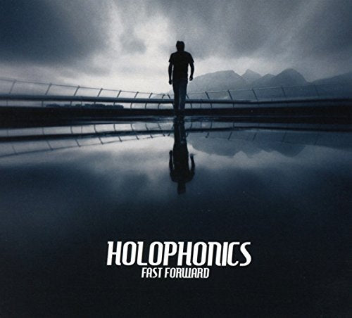 CD cover: lone figure walking towards mountains, reflective surface.