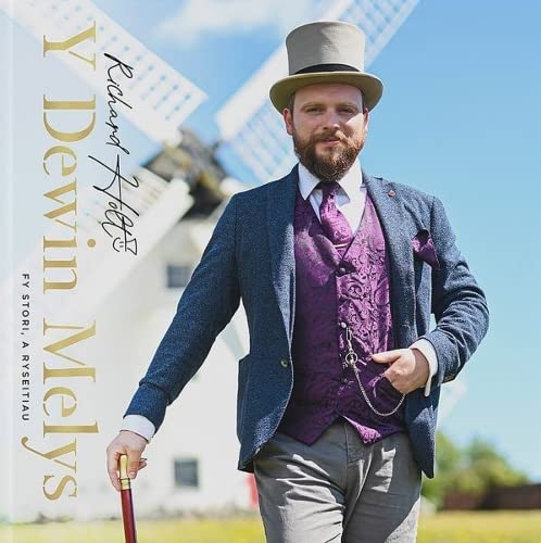 Book cover: man in vintage clothing stands before a windmill.