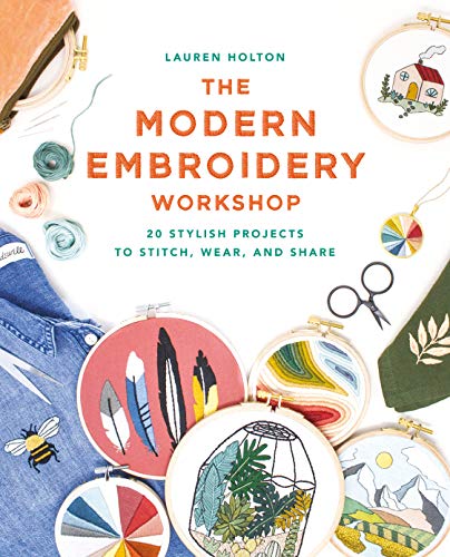 Embroidery book cover with colorful stitched designs, scissors, and denim.
