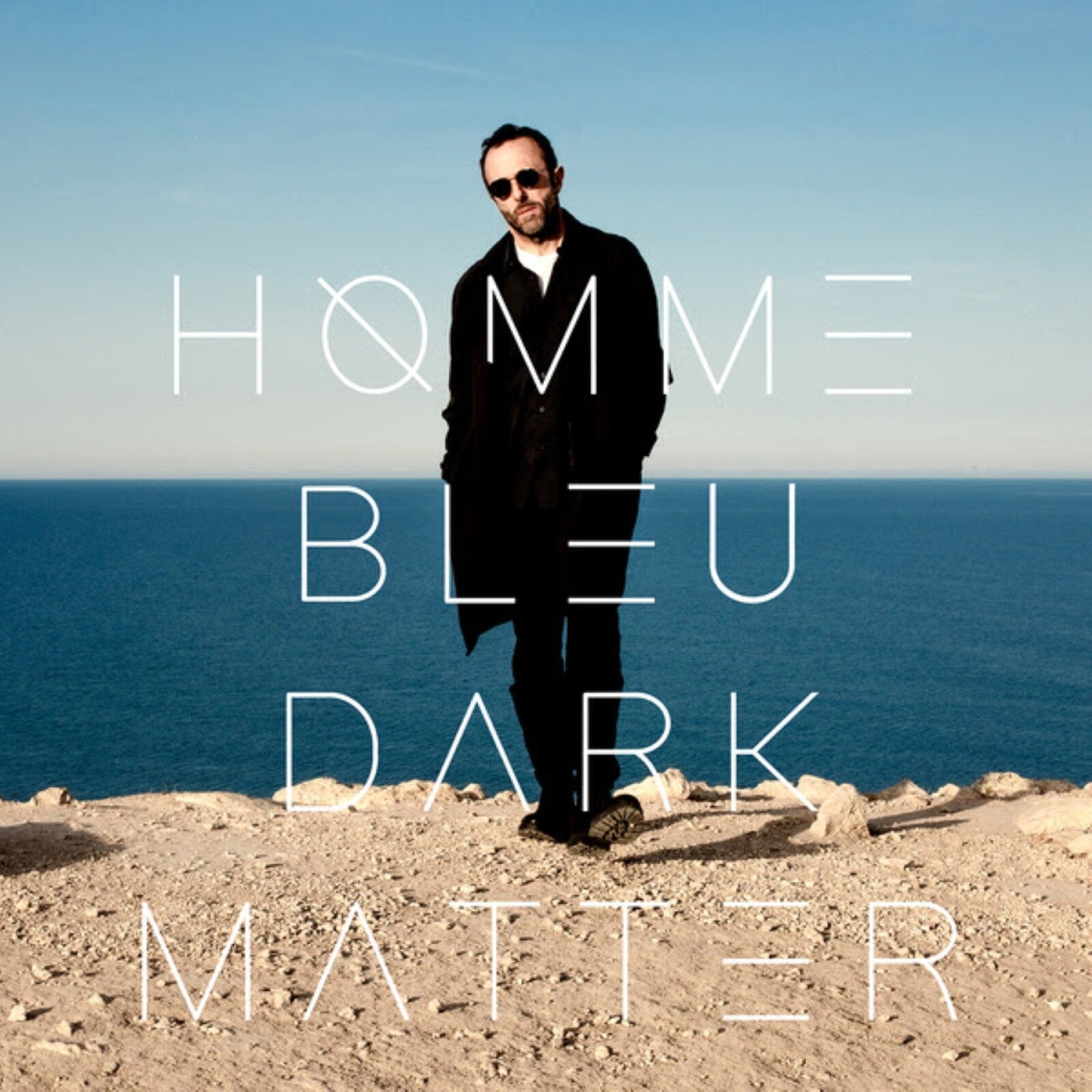 Album cover: man on cliff with text "HOMME BLEU - DARK MATTER".