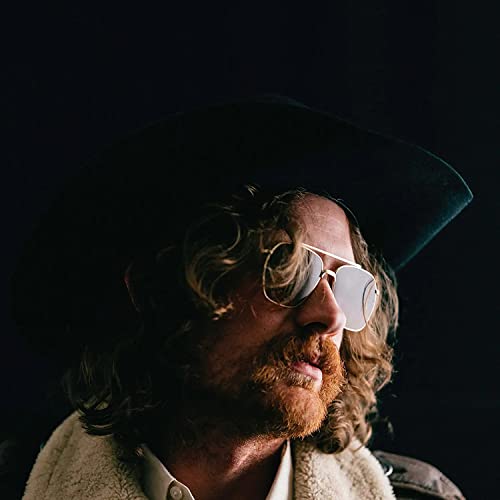Man with long hair and beard wearing a hat and sunglasses.