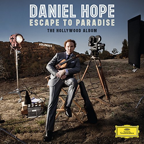 Violinist Daniel Hope seated with vintage film equipment, Hollywood Hills backdrop.