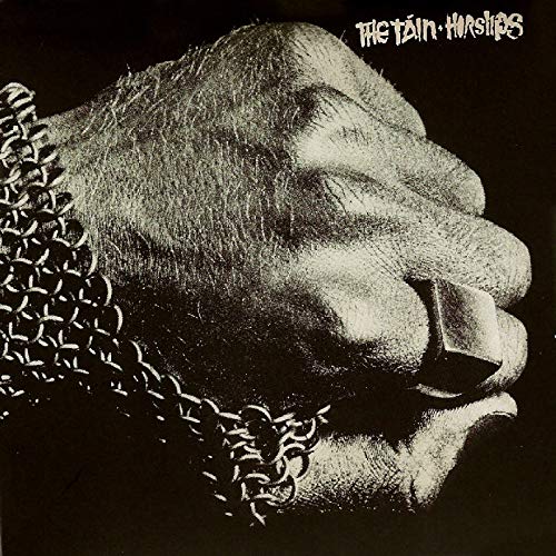 "Album cover with a hand wearing chainmail, against a black background."