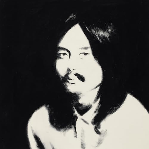 Black and white portrait of Haruomi Hosono with long hair and mustache.