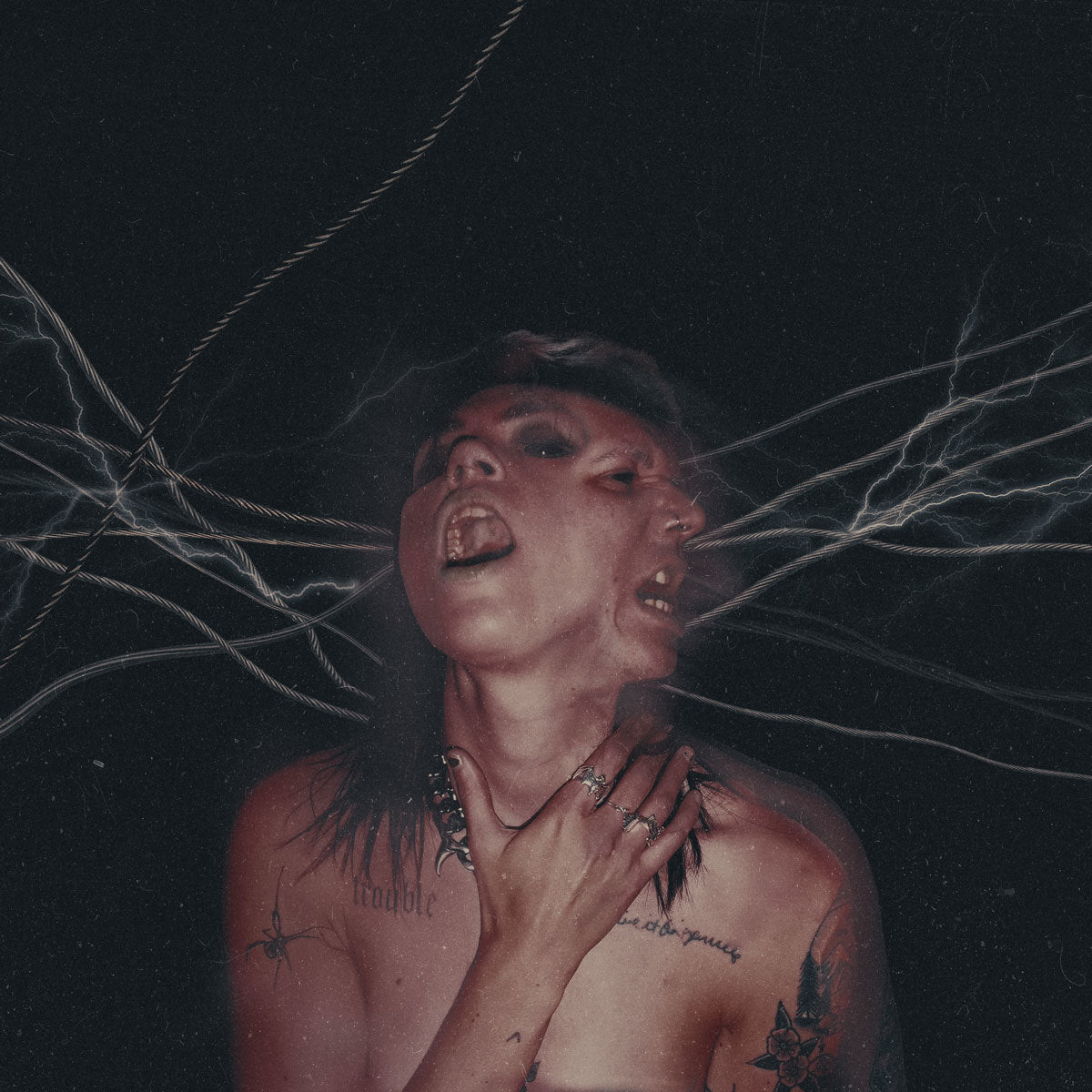 Close-up of a person with tattoos, looking up with a distressed expression.