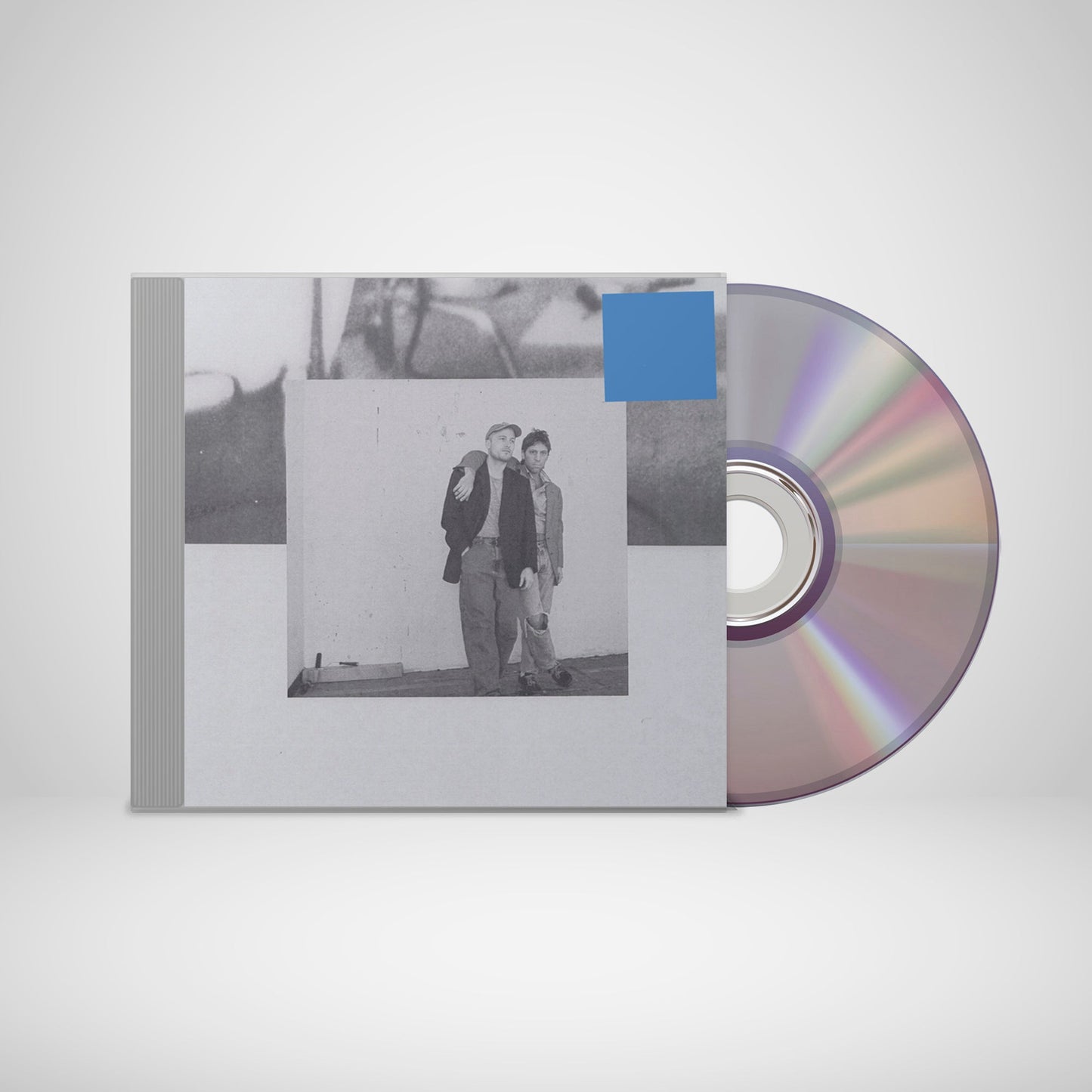 CD case with a black and white photo of two men, rainbow disc.