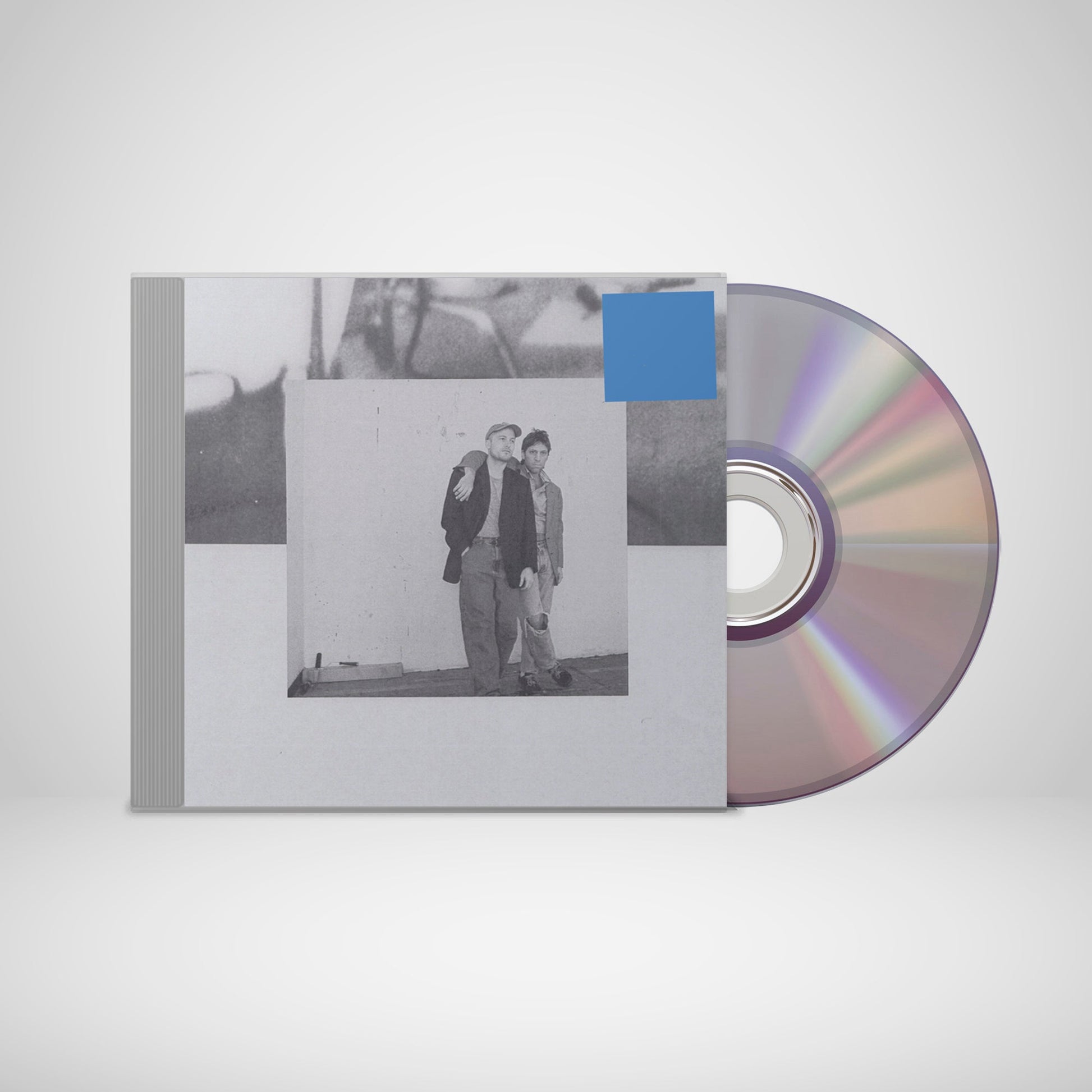 CD case with a black and white photo of two men, rainbow disc.