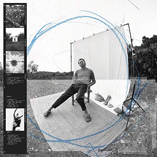 Album cover: man seated under a white fabric structure, tracklist on left.