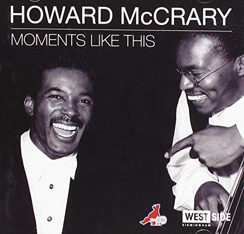 "Album cover featuring two smiling men, one holding a guitar, against a black background."