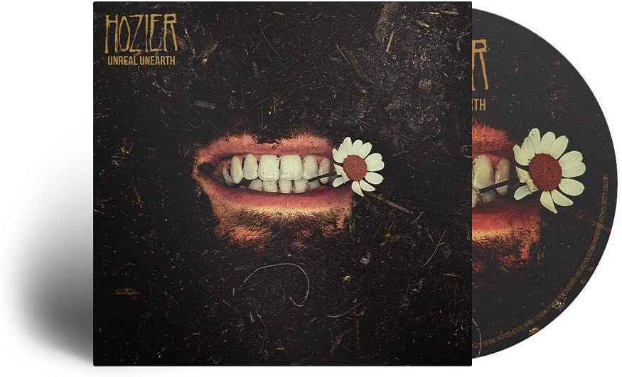 "Hozier's 'Unreal Unearth' CD with a mouth buried in dirt and holding flowers."