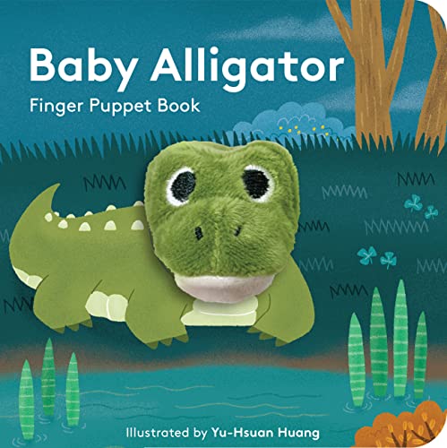 A green plush alligator finger puppet attached to the cover of a children's book.