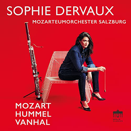 Woman with bassoon and red chair on a red background.