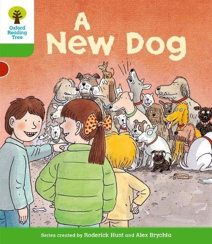 Children look at many dogs illustrated on a book cover.