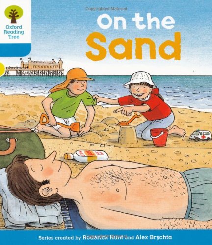 Children building sandcastles on a beach, with a sunbather in foreground.
