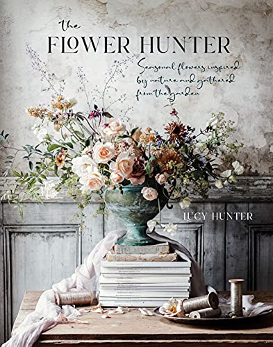Book cover featuring a floral arrangement in a vase atop a stack of books.