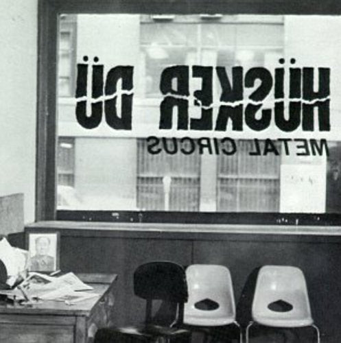 Black and white photo of “Husker Du” band name on a storefront window.
