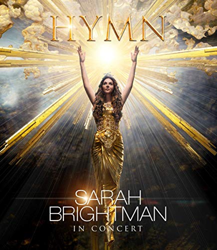 Sarah Brightman in gold gown with arms raised, radiant light background.