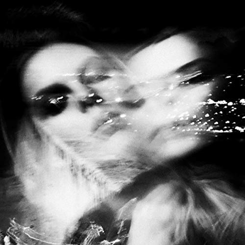 Black and white distorted portrait of a person partially submerged in water.