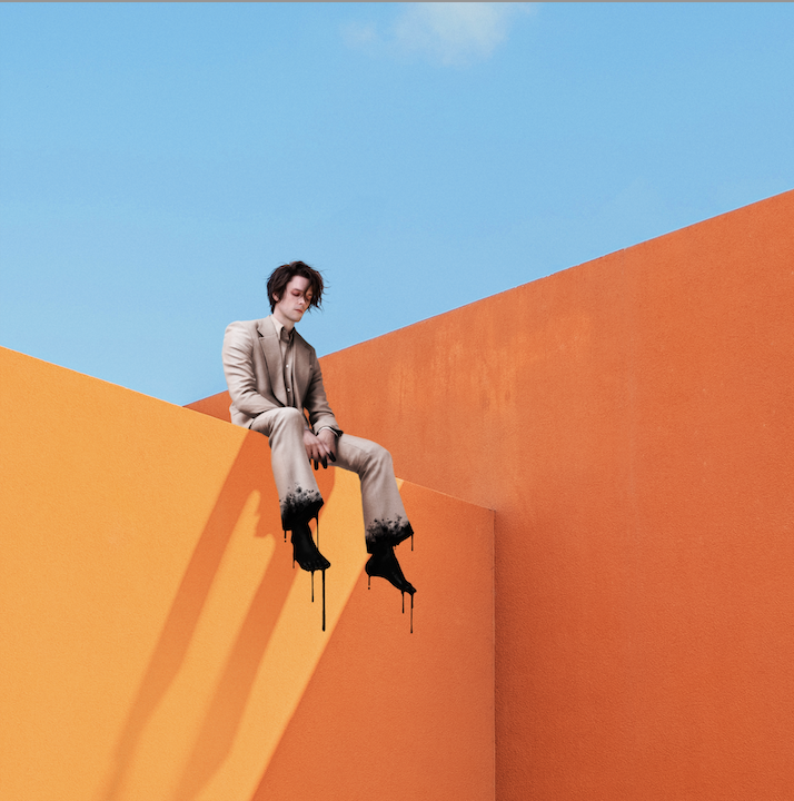 Album cover: person in suit with melting feet against orange walls.