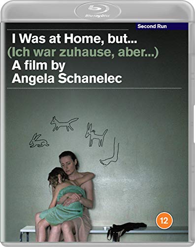 Blu-ray cover: woman holding child in front of a green wall with drawings.
