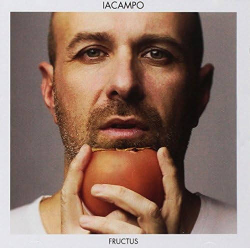 Close-up of a man holding a tomato, album cover for Iacampo - Fructus.