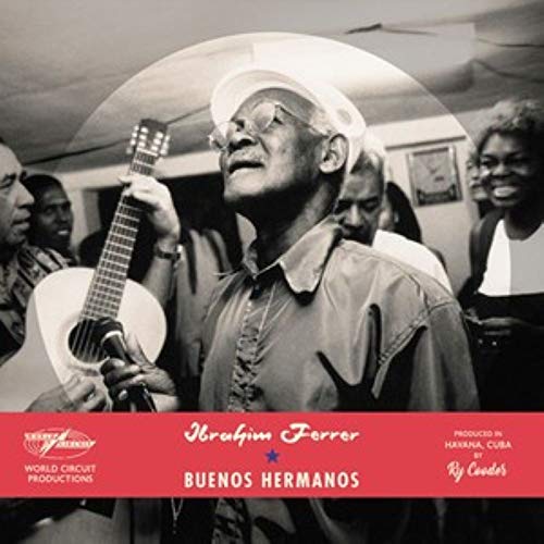 Black and white image of a man holding a guitar, surrounded by people, on a CD cover.