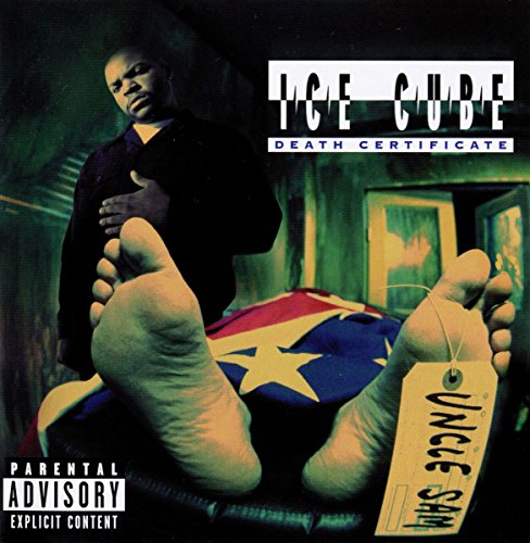 Ice Cube standing over a body covered by a flag with an Uncle Sam tag.