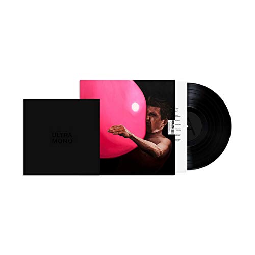 A man with a strained expression holds a large, pink vinyl record.