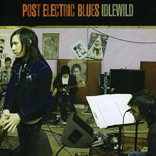 Band Idlewild album cover featuring musicians in a room with posters.