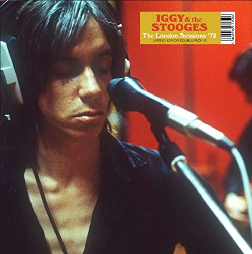 Iggy Pop with headphones and microphone on orange vinyl record cover.