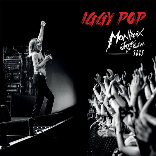 Black and white photo of shirtless Iggy Pop performing before a cheering crowd.