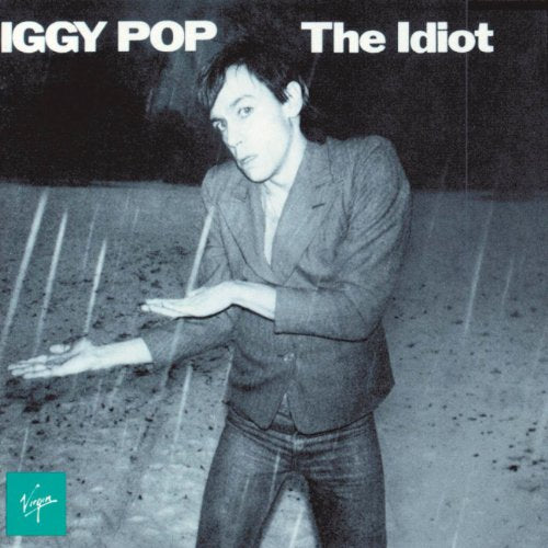 Iggy Pop poses in a blazer against a rainy background on The Idiot album cover.