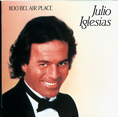 Julio Iglesias album cover, portrait of smiling man in a tuxedo.