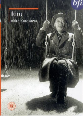 Black and white DVD cover of Ikiru showing a man on a swing in snow.